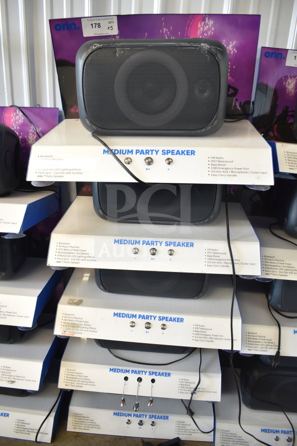 Stack of five Onn Medium Party Speakers with Bluetooth, IPX7 waterproofing, LED lighting effects, and easy-carry handles.