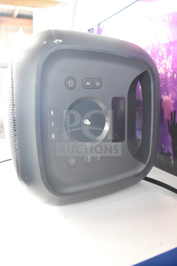 Onn Medium Party Speaker, black, with control buttons on top; display item from store, in good condition.