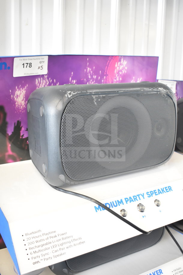 Onn Medium Party Speaker display; features Bluetooth, 20-hour playtime, 200W power, LED lighting. Quantity five available.