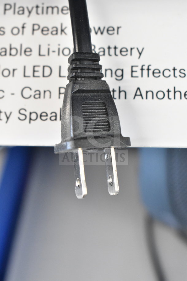 Power cord for Onn Medium Party Speaker with legible text in background detailing features like Li-ion battery and LED effects.
