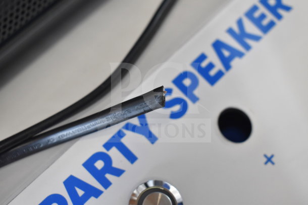 Onn medium party speaker with visible cable and control knob, part of 4-store display auction.