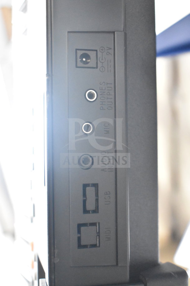 Digital keyboard connection panel showing 9V DC, audio input, mic, phones output, USB, and MIDI ports. Good condition.