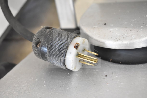 Close-up of a plug on a Bizerba VS12F slicer, showing wear and minor dirt, indicative of use.