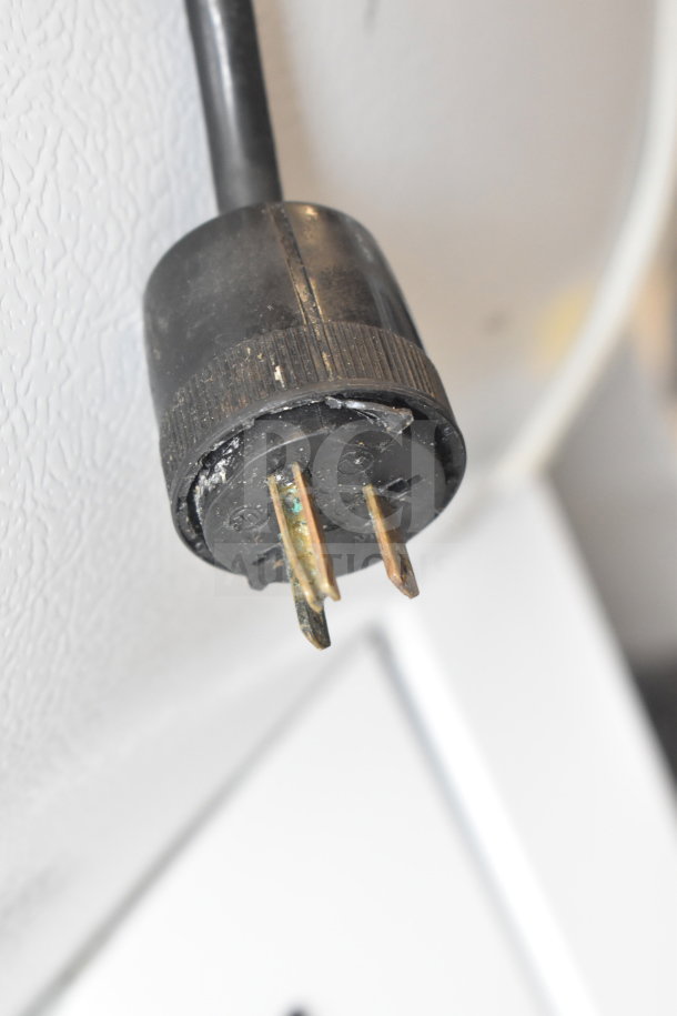 Close-up view of a power plug for the Master-Bilt QMVM-48L commercial merchandiser, 115/208-230 volts, 1 phase.