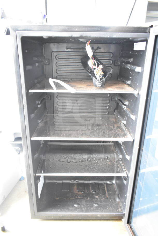 Arctic King ARV115B1AST beverage cooler, 115-can capacity, interior shelves, wiring exposed, used condition. Model label visible.