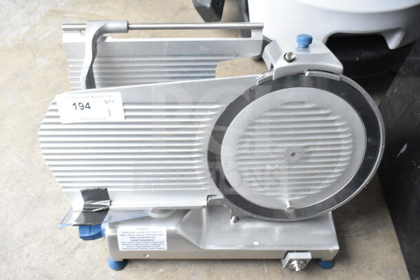 Edlund EDV-12 commercial meat slicer with blade sharpener, 120V, 1 phase. Carriage needs reattachment, auction tag visible.