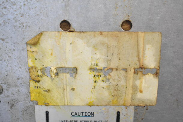 Yellowed, deteriorated caution label on a Southbend Marathoner Gold commercial convection oven, indicating age and wear.