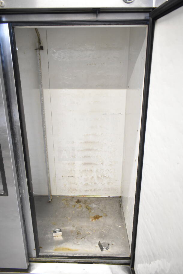 True T-49 Commercial 2 Door Reach In Cooler, interior view. Features 115 Volts, 1 Phase. Visible wear inside.