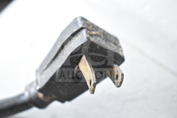 Close-up of a worn power plug from the True T-49 Commercial 2 Door Reach In Cooler, showing visible wear on prongs.