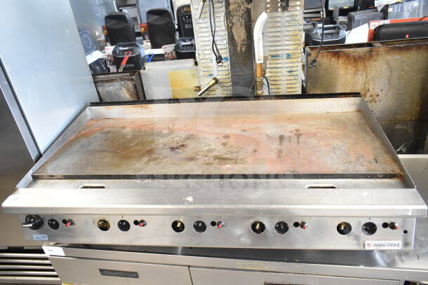 Garland Commercial Gas Griddle, countertop model with multiple control knobs. Shows signs of use, sturdy stainless steel build.