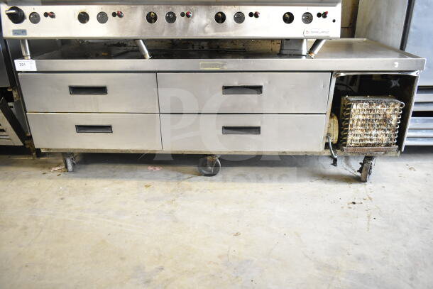 Delfield commercial 4-drawer chef base on casters, 115 volts, 1 phase, stainless steel, moderate wear, visible coils on side.