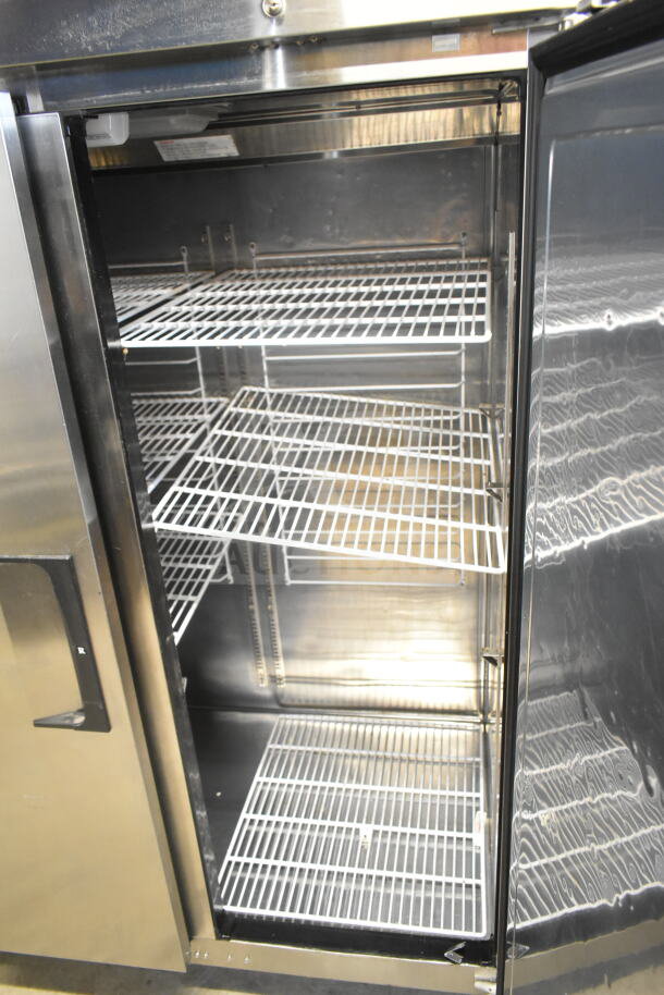 Everest ESR2 Commercial 2 Door Reach In Cooler with multiple wire shelves. Model ESR2, 115 volts, 1 phase, excellent condition.