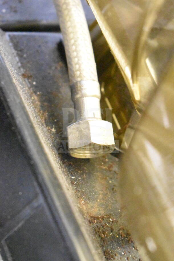 Close-up of a connection fitting on a Thermoplan Mastrena espresso machine, showing signs of wear.