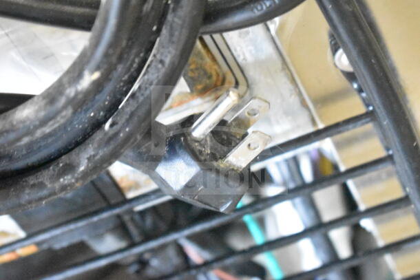 Power cord of Everest ETBF1 Commercial Freezer, showing a three-prong plug. Cord appears used and slightly worn.