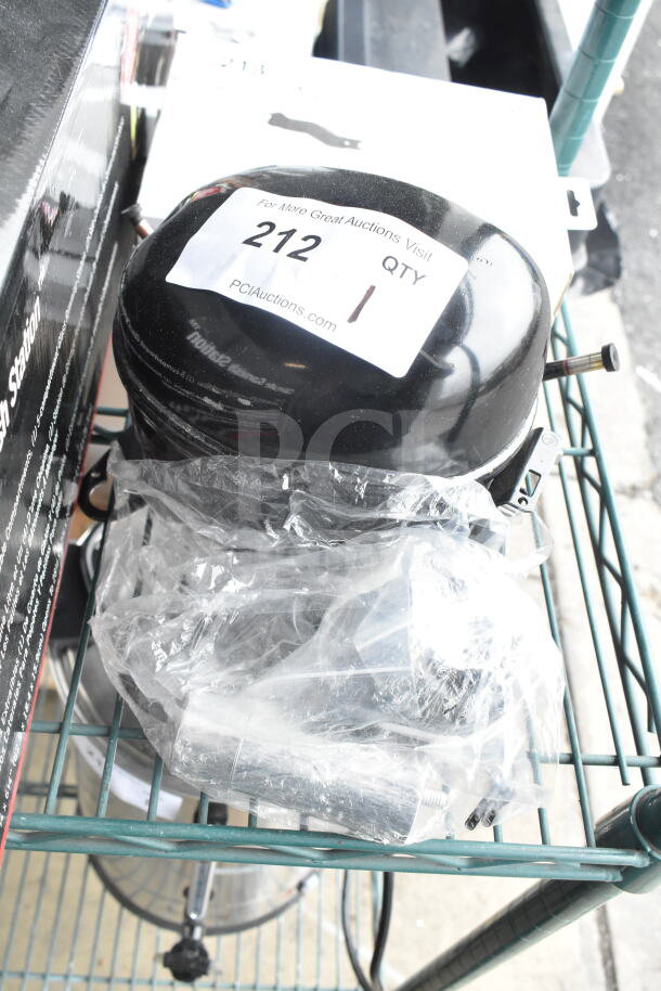 BRAND NEW SCRATCH AND DENT Embraco EM2X3125U Avantco Compressor, 115-127V, 1 Phase. Auction tag with lot number visible.