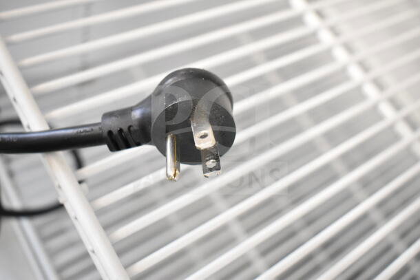 Plug detail of True TSCI-600R-G-PH commercial cooler; single door model, 115 volts, 1 phase, with metal shelving.