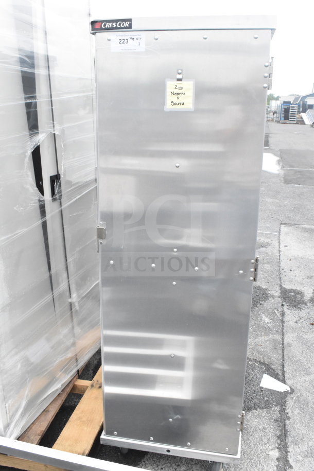 BRAND NEW CresCor 101141820 aluminum 20 tray meal delivery cart, scratch and dent, visible hinge and latch, parked outside.