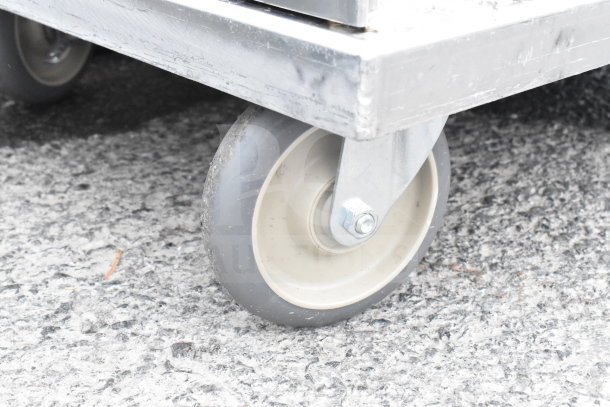 Brand new CresCor aluminum meal delivery cart wheel, showing slight scratches and dents.