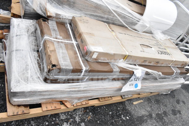 Four new scratch and dent items including a shelf and work table, wrapped on a pallet. Item tag JUN26-121 visible.