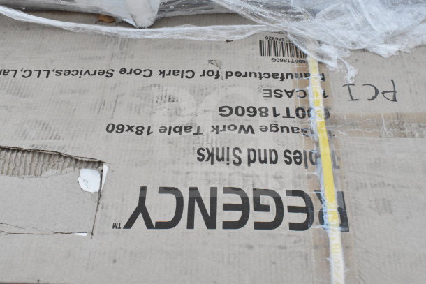 Cardboard box labeled "Regency" with visible scratches and dents, packaging a work table 18x60 inches. Brand new condition.
