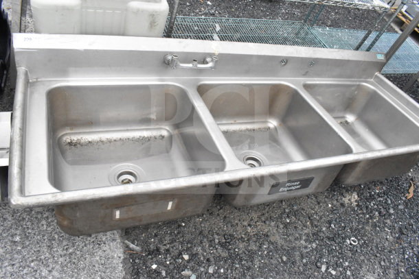 Commercial 3 bay stainless steel sink, missing legs. Features three compartments, faucet, and "Rinse" label. Used condition.