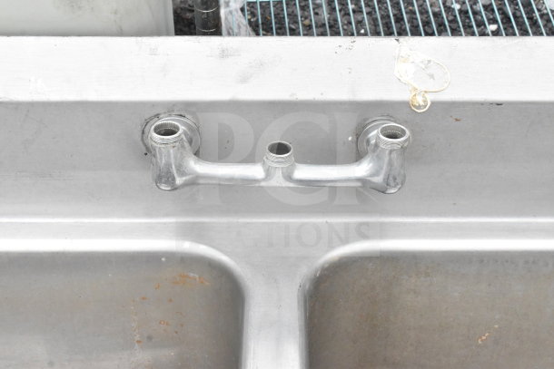 Commercial 3 bay sink, stainless steel, no legs, faucet mount visible, signs of use, ideal for restaurant kitchens.