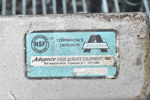 Commercial 3 bay sink without legs, featuring an NSF label by Advance Food Service Equipment, Inc., showing wear.