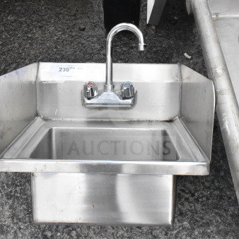 Commercial single bay sink with faucet, dual handles, and side splash guards. Stainless steel, used condition.