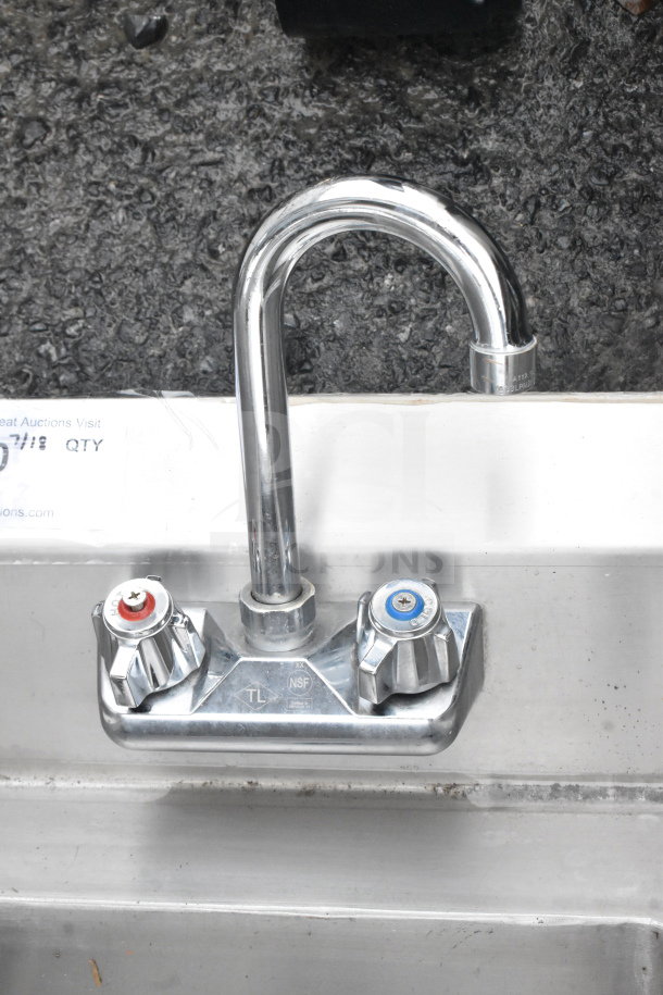 Commercial single bay sink with faucet, dual handles, and side splash guards. NSF certified, stainless steel, used condition.