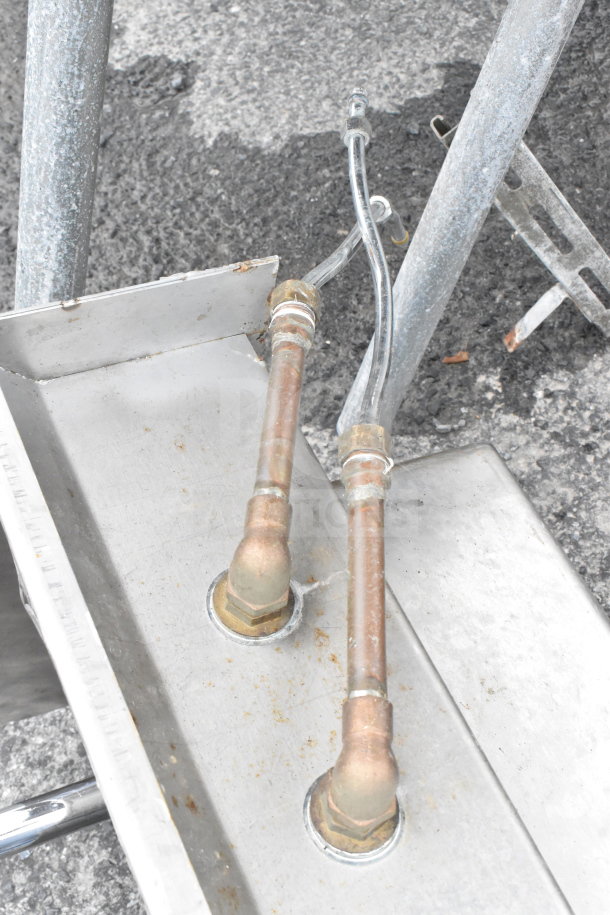 Commercial single bay sink with faucet, handles, and side splash guards. Stainless steel, visible plumbing, used condition.