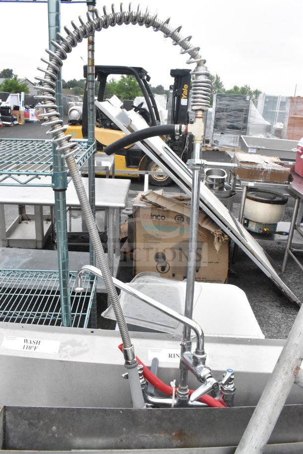 Commercial 3 bay sink with dual drain boards, includes faucet and spray nozzle attachment. Stainless steel, clean condition.