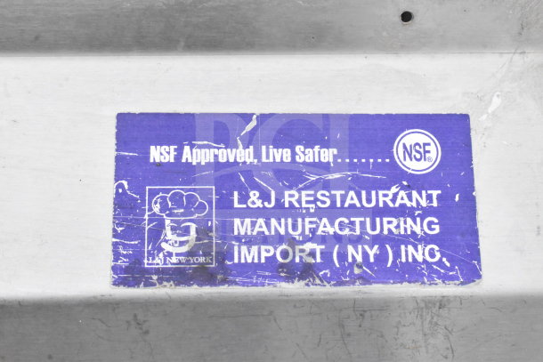 NSF-approved 3-bay commercial sink by L&J Restaurant Manufacturing, featuring dual drain boards and a spray nozzle attachment.
