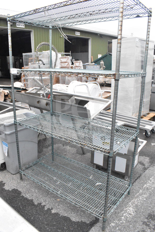 Chrome finish 4-tier wire shelving unit in outdoor setting, used condition. Buyer must dismantle for shipping.