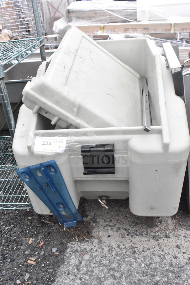 Poly portable ice bin on commercial casters, features heavy-duty plastic body, lid, and drainage spout, in used condition.