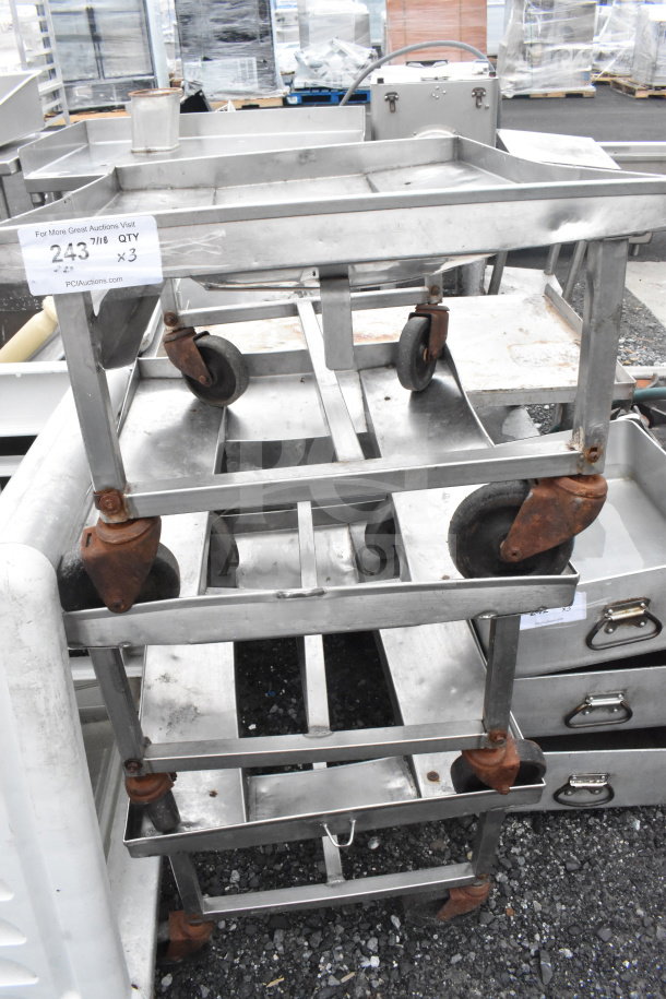 Three industrial dollies with commercial casters, metal frames, showing rust on wheels, stacked outdoors. Label indicates quantity 3.