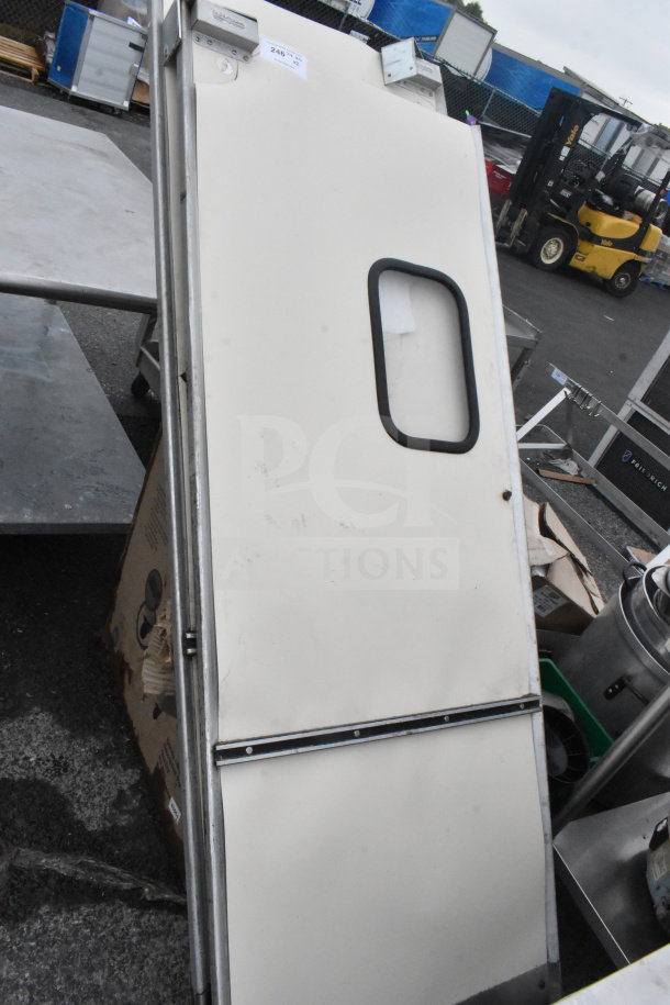 Eliason swinging kitchen doors, white with window, metal frame, gently used condition, auction tag visible.
