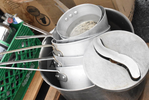 Pallet lot with stock pots, sauce pans, cylindrical bins, utensils, and a fire extinguisher. Mixed condition.