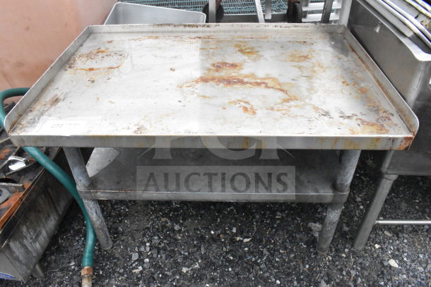 Commercial equipment stand with under shelf, stainless steel, shows rust and wear, includes visible tag "252".