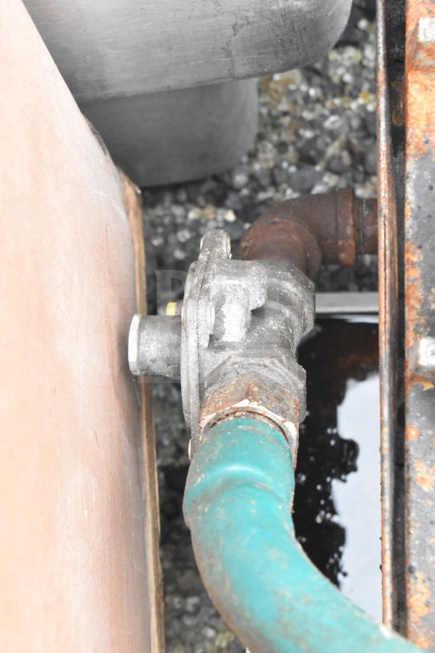 Damaged section of Cook Rite Commercial Gas Range with visible rust on piping and connections.