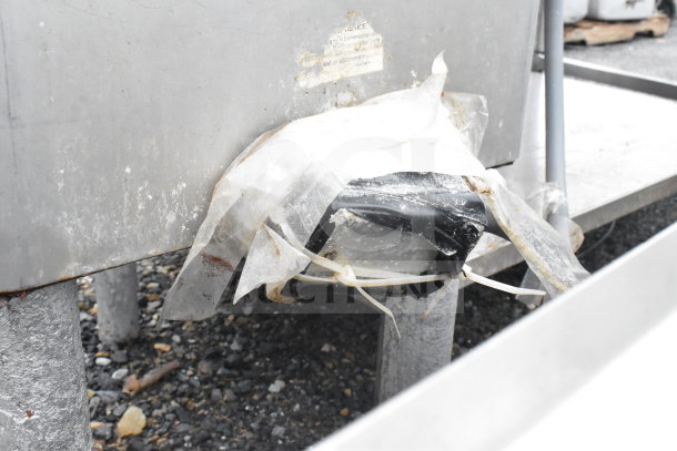 Hobart Commercial Meat Mixer Grinder, metal casing, signs of wear and rust, taped area on the exterior, visible utility tags.