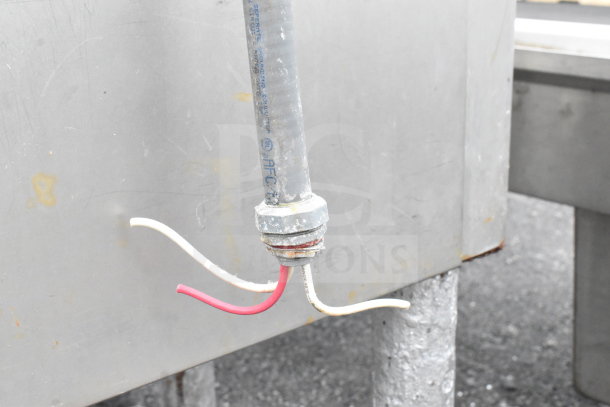 Hobart commercial meat mixer grinder with visible metal pipe and wires, suggesting wear and electrical setup.