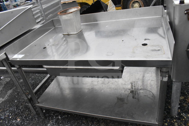 Commercial stainless steel table with drawer and under shelf, featuring a high backsplash. Good used condition.
