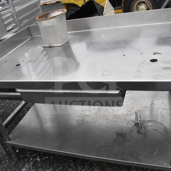 Commercial stainless steel table with drawer and under shelf, featuring a high backsplash. Good used condition.