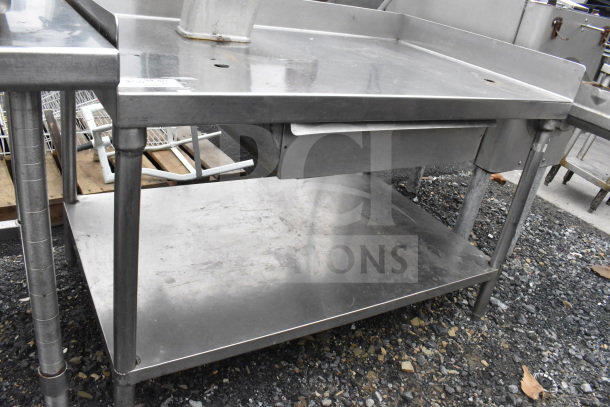 Commercial stainless steel table with drawer and under shelf. Features durable legs, used condition.