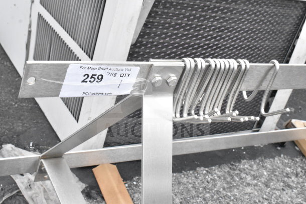 Commercial pot rack with multiple S hooks, steel construction, auction tag showing item number 259, PCI Auctions label.