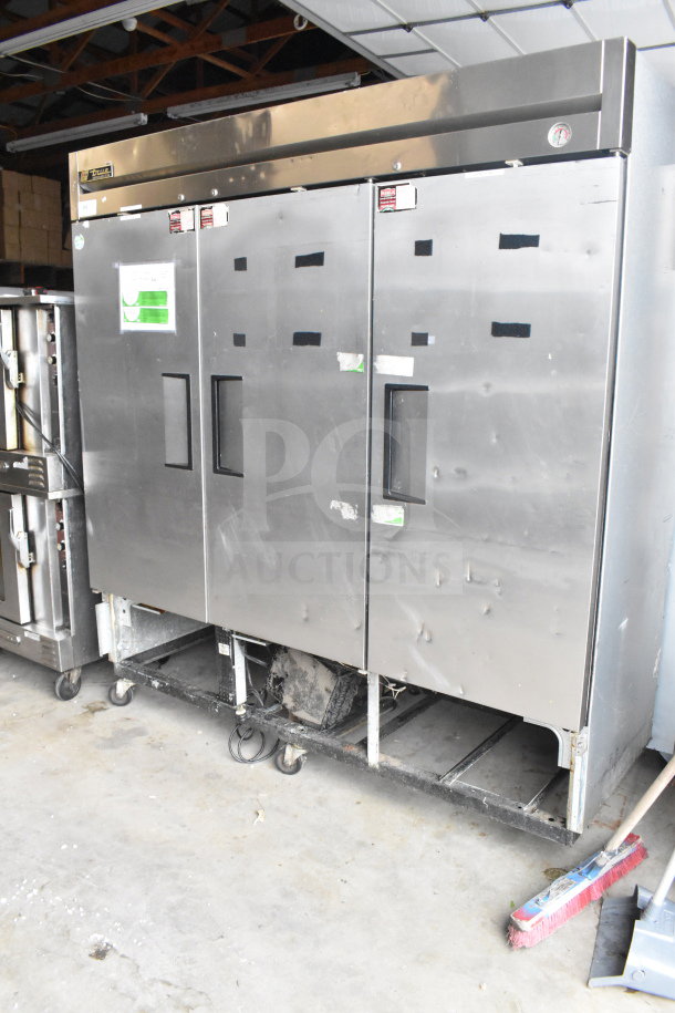 True T-72 3 Door Reach-In Cooler, 115 volts, 1 phase. Stainless steel, commercial use, some exterior wear visible.