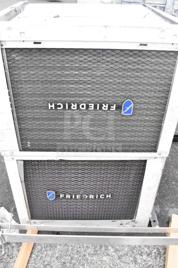 Two Friedrich KCL24A30B-A 23,000 BTU window wall air conditioners, featuring front grille and logo in solid condition.
