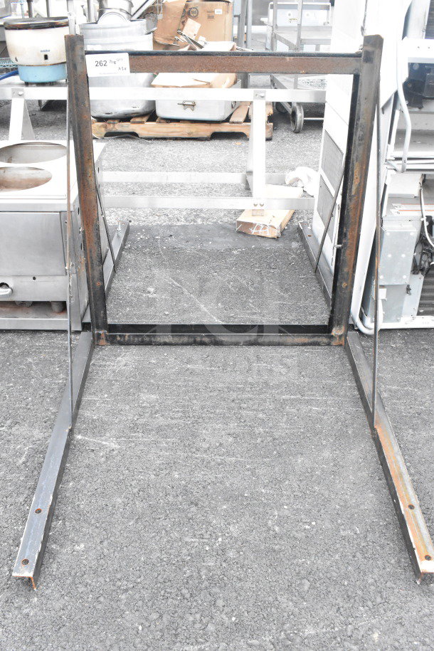 Two metal frames with rust, standing on asphalt. Auction label "262" visible, indicating a quantity of two.