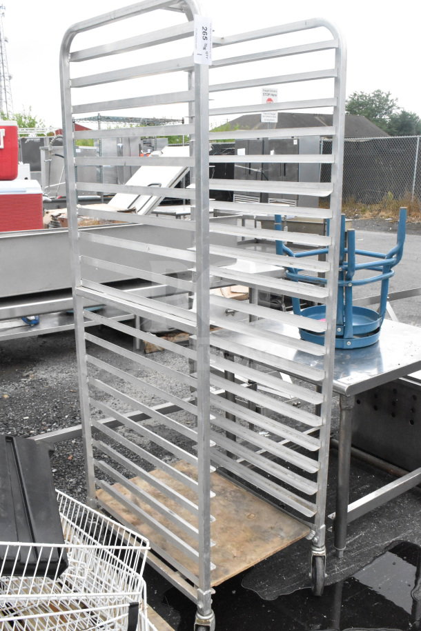 Commercial transport pan rack with multiple shelves, on large commercial casters. Metal construction, used condition.
