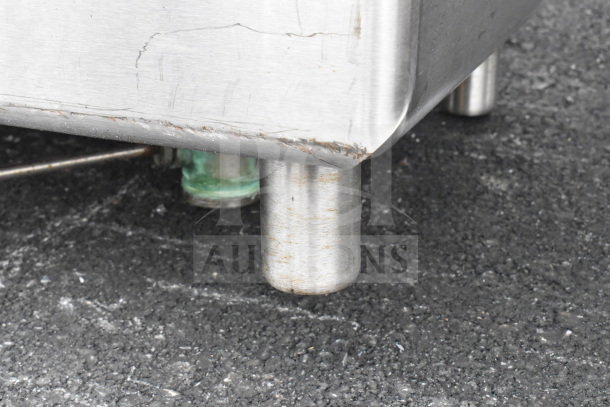 Commercial 3 bay sink with dual drain boards, no legs. Stainless steel, visible scratches and minor wear.